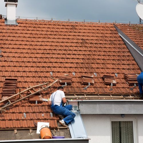 Two men working on the roof