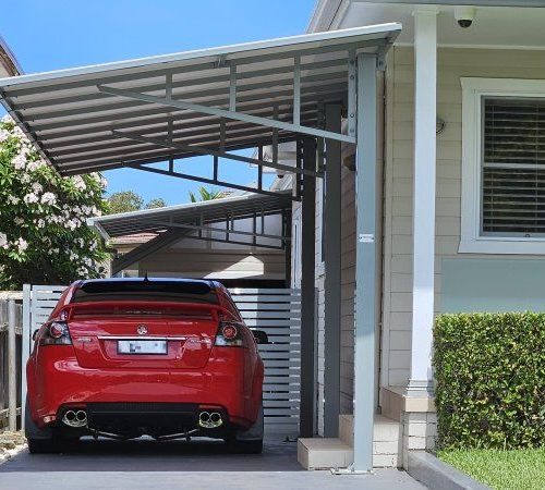 car under flat roof cantilever carport in Mortlake